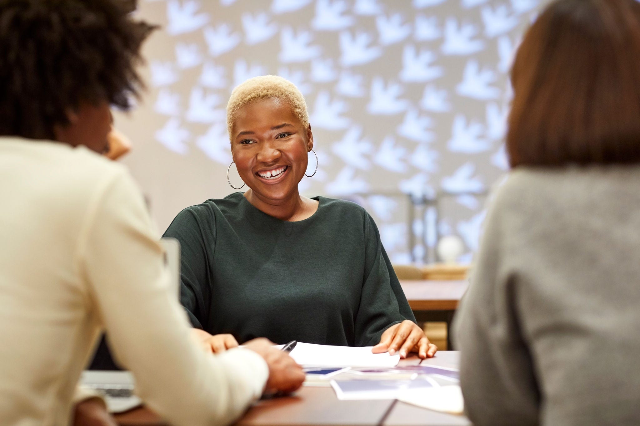 Smiling entrepreneur with coworkers in office